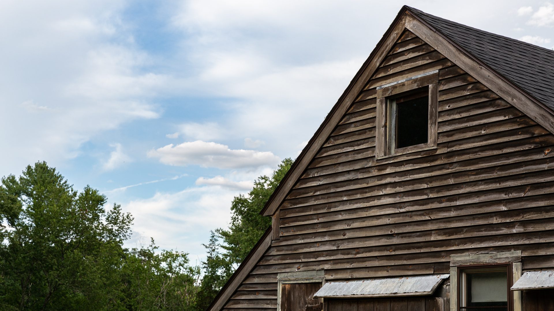 Close-up architectural detail of the farmhouse showing its colonial-era construction