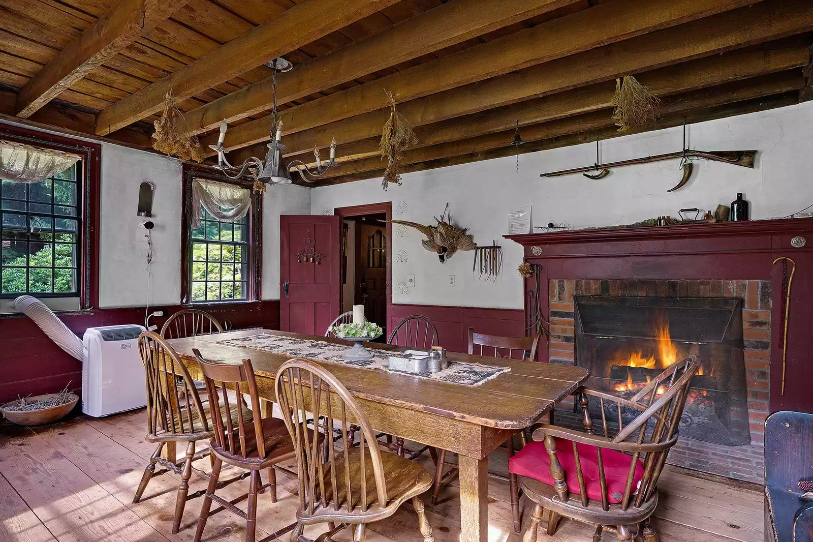 Dining room with fireplace inside the historic farmhouse at the Old Arnold Estate
