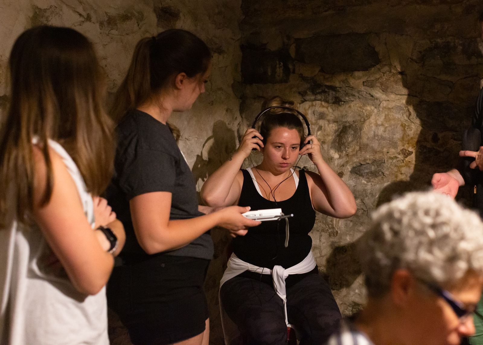 Small group taking part in an investigation experience inside the historic farmhouse